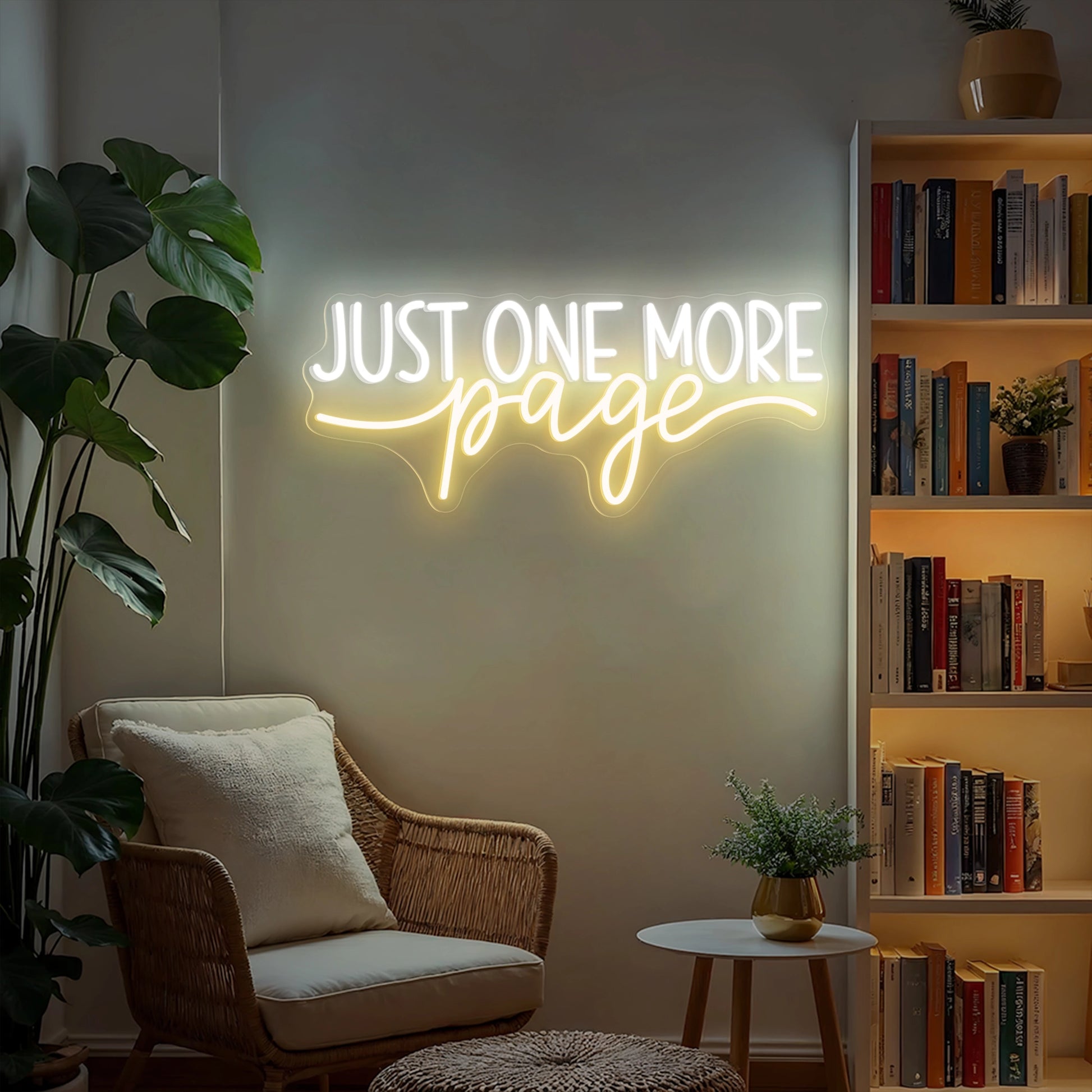Just One More Page neon sign glowing warm white and yellow on a wooden bookshelf in a cozy home library