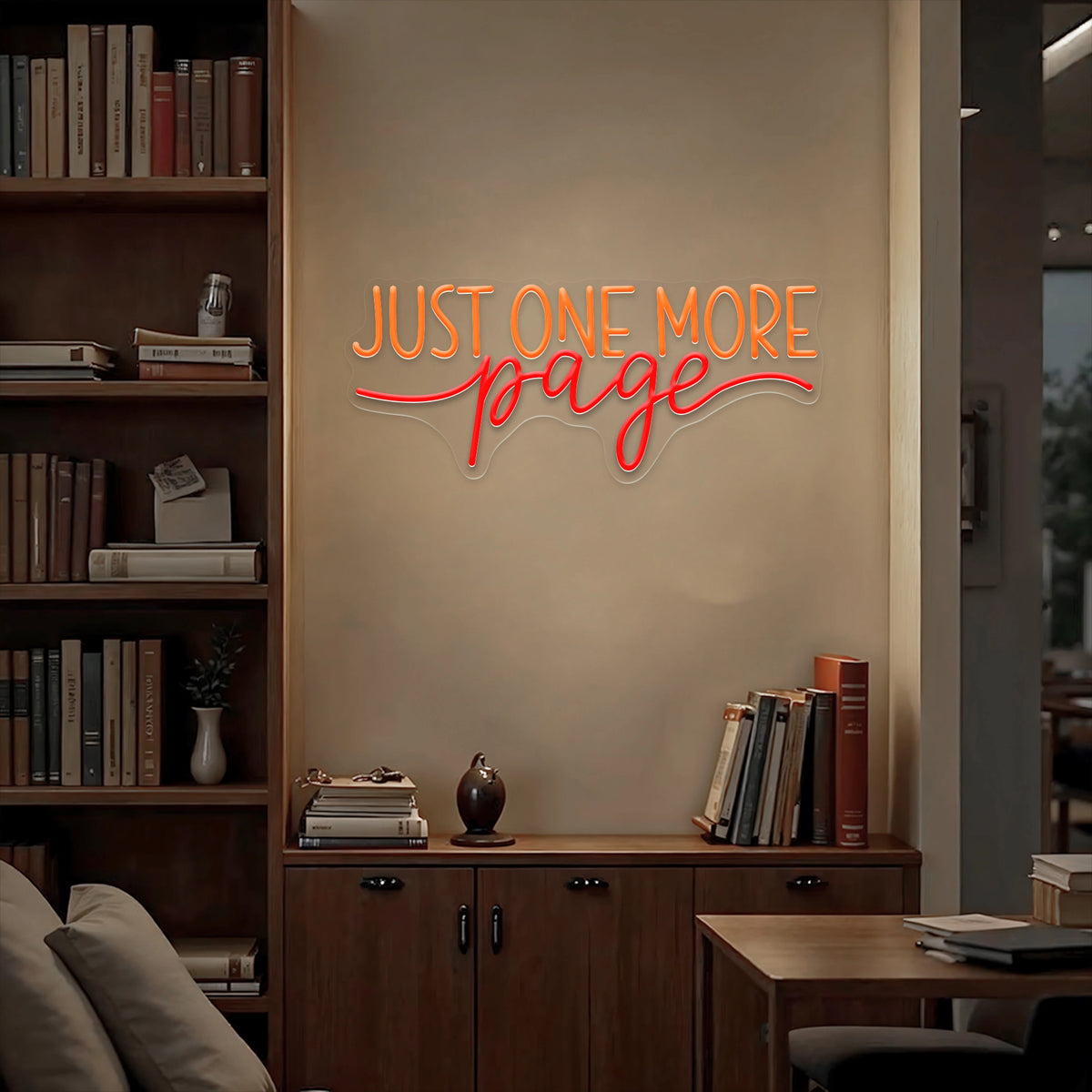 Just One More Page neon sign glowing warm white and yellow on a wooden bookshelf in a cozy home library