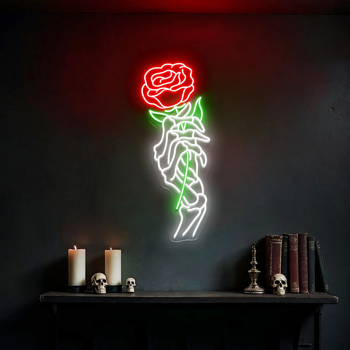 Skeleton hand holding a red rose neon sign glowing on a dark wall above gothic shelf decor